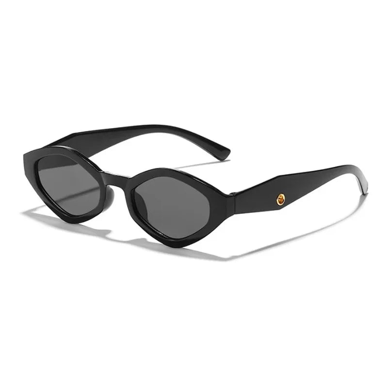 Bold cat-eye sunglasses with a thick black frame and dark lenses, featuring a stylish upswept silhouette.
