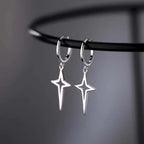 Silver gothic star drop earrings with a hollow design and hoop attachments, showcasing a bold punk aesthetic.