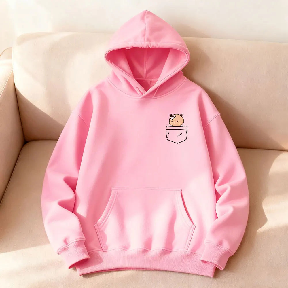 Oversized pink hoodie featuring a cartoon bear graphic in the pocket, with a cozy front kangaroo pocket and hood.