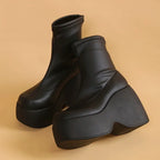 Chunky black eco-leather boots with a high platform and block heel, featuring an integrated inner zipper for easy wear.