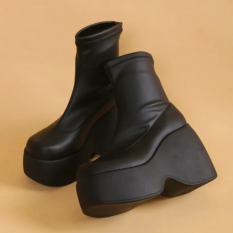 Chunky black eco-leather boots with a high platform and block heel, featuring an integrated inner zipper for easy wear.