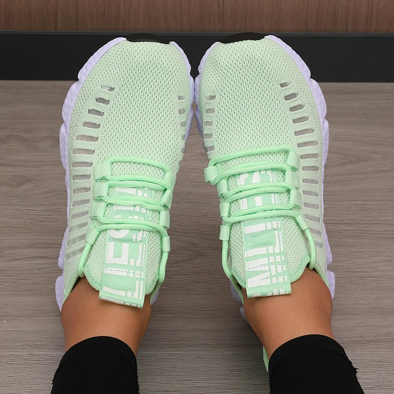 Light green LOVORA™ Aura breathable knitted performance sneakers with a flexible lace-up design and a ventilated, elastic knit upper.