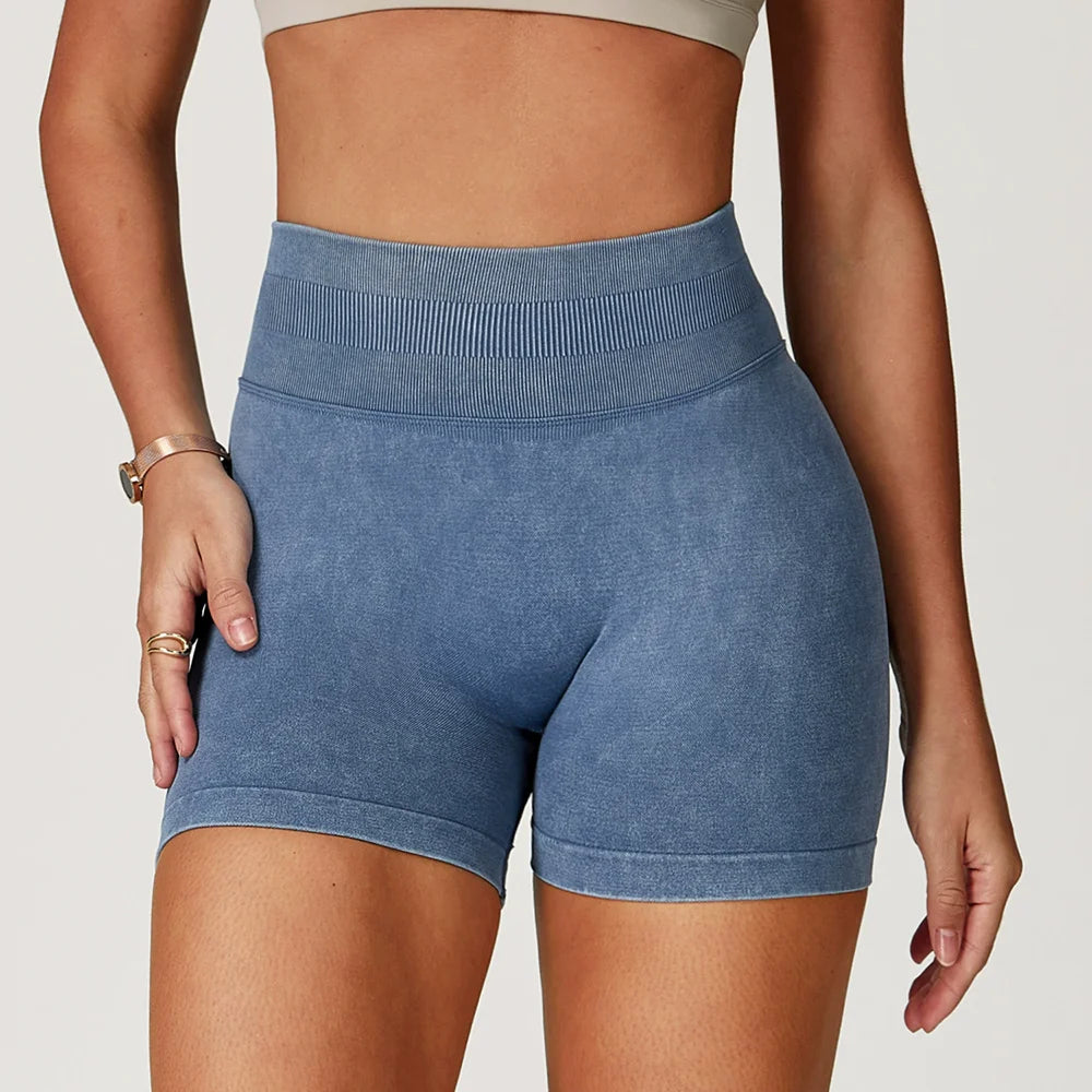 High-waisted, sand-washed gym shorts in a soft blue hue, featuring a ribbed waistband and a body-sculpting fit.