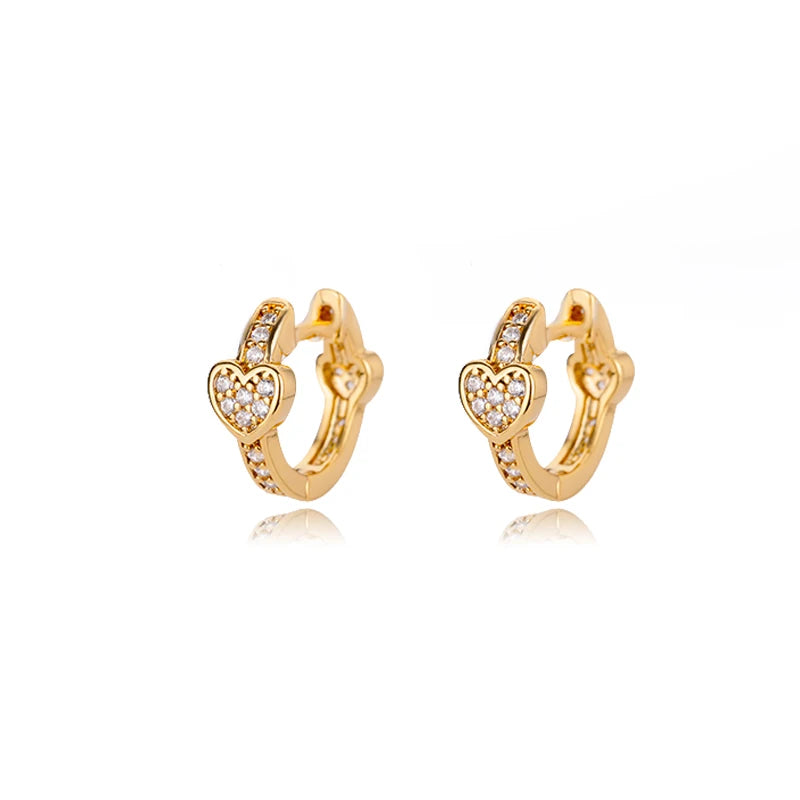 Gold huggie earrings featuring a heart design and sparkling accents, showcasing a polished, sleek finish.