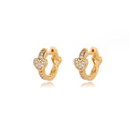 Gold huggie earrings featuring a heart design and sparkling accents, showcasing a polished, sleek finish.