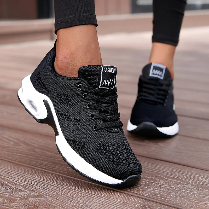Black LOVORA™ Aura Air Boost Platform Sneakers featuring breathable mesh and a white platform sole, worn with black leggings.