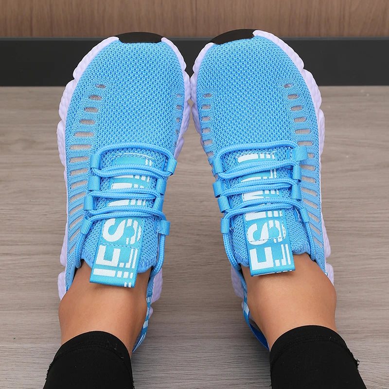 Bright blue knitted performance sneakers with a breathable mesh design, featuring a secure lace-up system and lightweight sole.