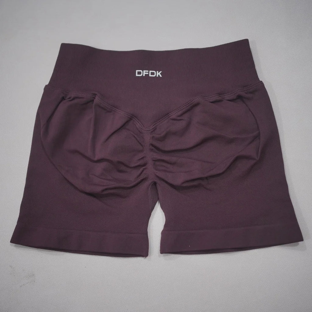 High-waisted, seamless gym shorts in a rich plum color with a scrunch-butt design and reinforced waistband.