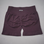 High-waisted, seamless gym shorts in a rich plum color with a scrunch-butt design and reinforced waistband.