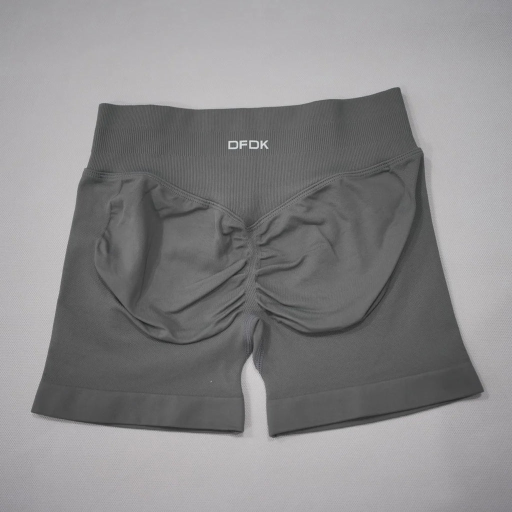 High-waisted, seamless gym shorts in dark gray, featuring a scrunch-butt design and wide waistband for tummy control.