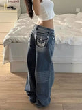 Baggy denim cargo jeans in a faded blue wash, featuring oversized 3D side pockets and a relaxed wide-leg silhouette.