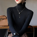 Slim-fit black ribbed mock-neck pullover worn with a silver necklace, showcasing a smooth, elegant silhouette.