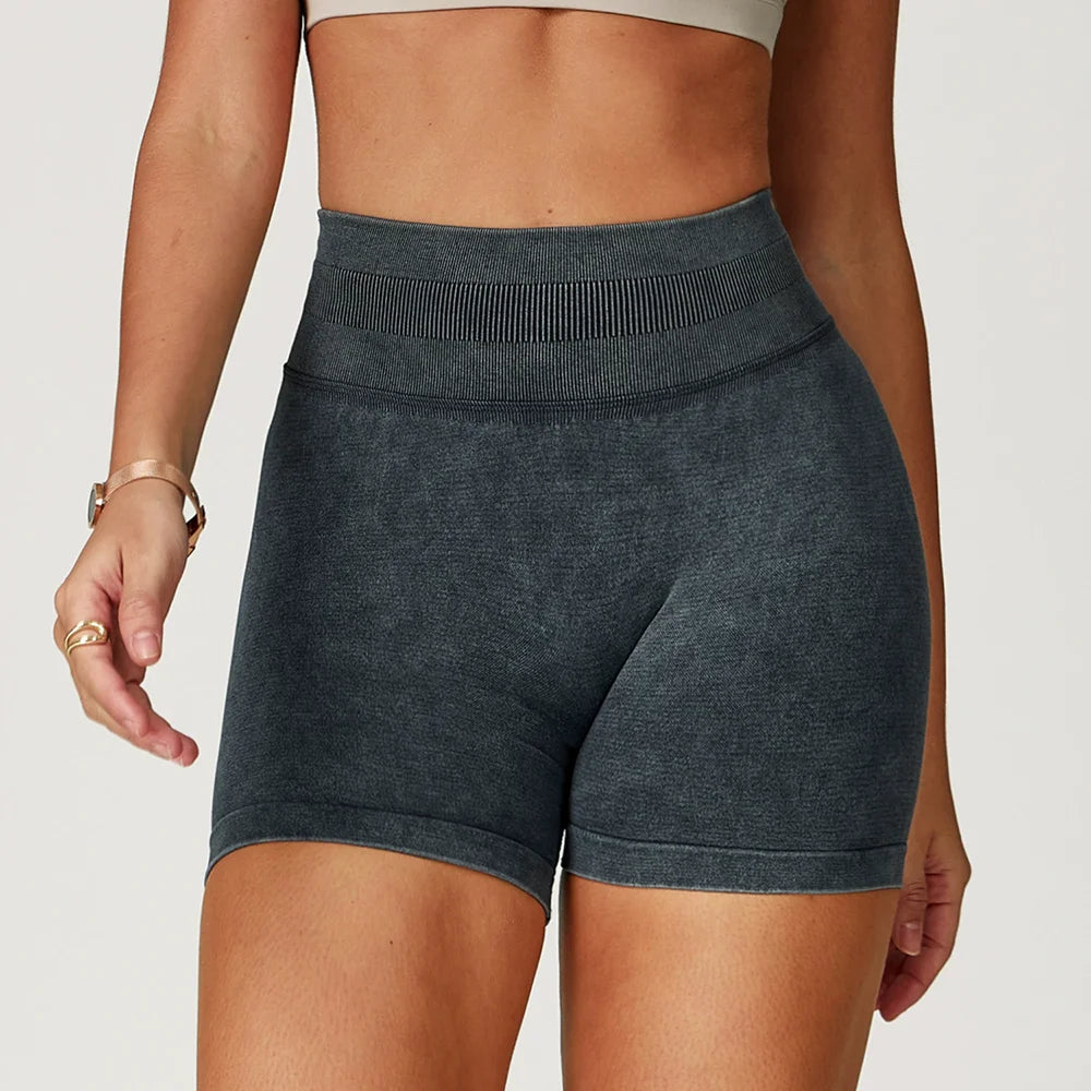 High-waisted, dark heathered gym shorts with a seamless design and textured finish, perfect for activewear styling.