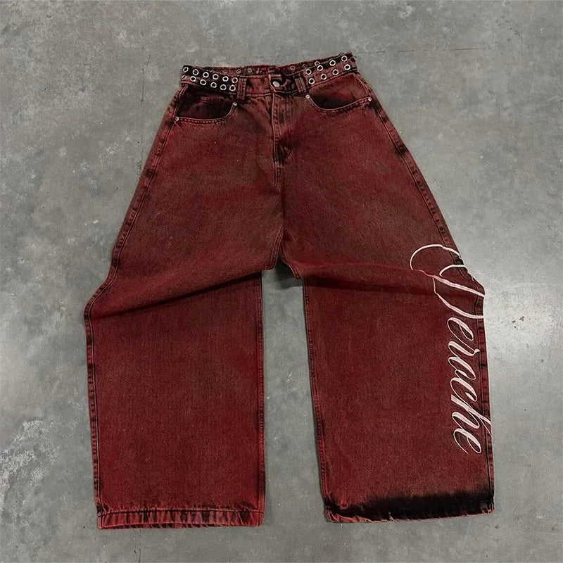 Baggy distressed denim jeans in a deep burgundy color with oversized wide legs and embroidered lettering on the side.