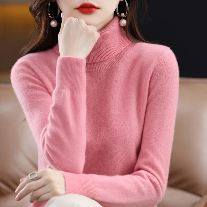Soft pink turtleneck sweater in merino wool and cashmere blend, featuring a relaxed fit and ribbed cuffs.