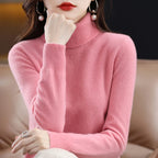Soft pink turtleneck sweater in merino wool and cashmere blend, featuring a relaxed fit and ribbed cuffs.