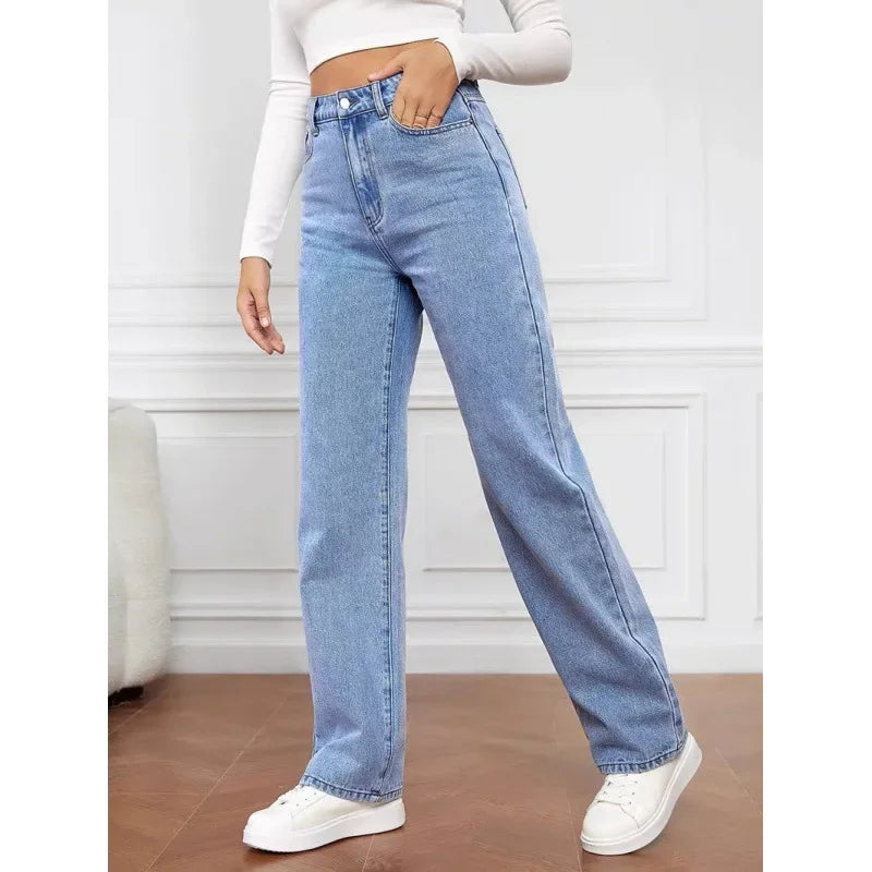 High-waisted, wide-leg denim jeans in light blue, paired with a fitted white crop top and white sneakers.
