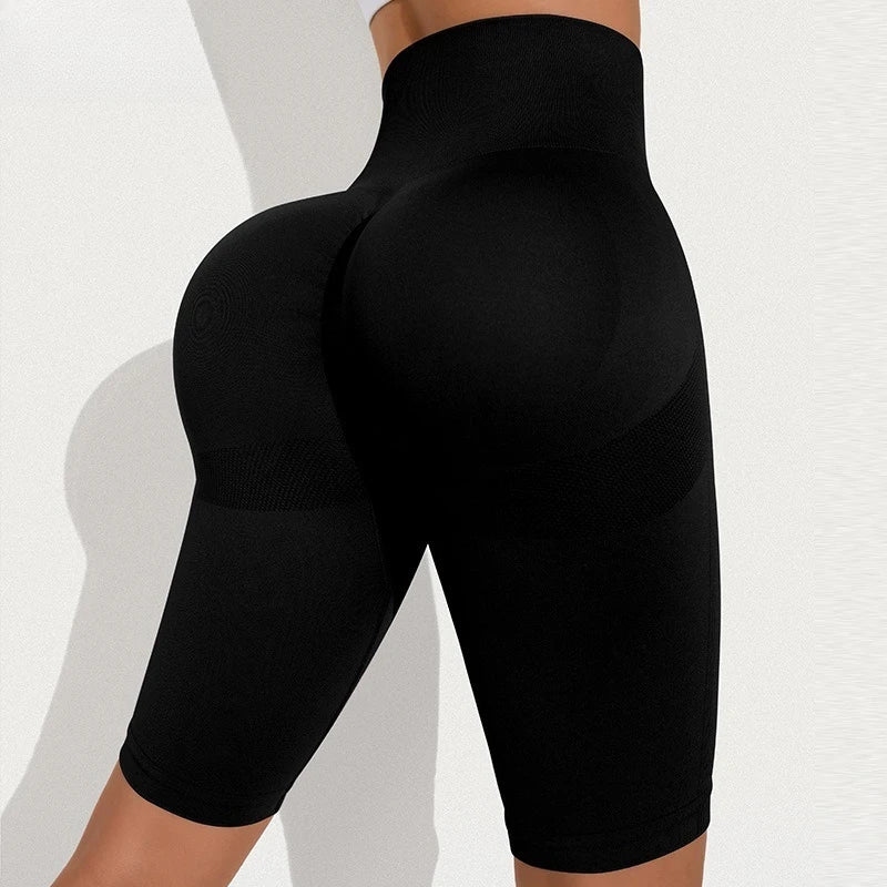 High-waisted black seamless athletic shorts featuring a ribbed contour design and compression support.