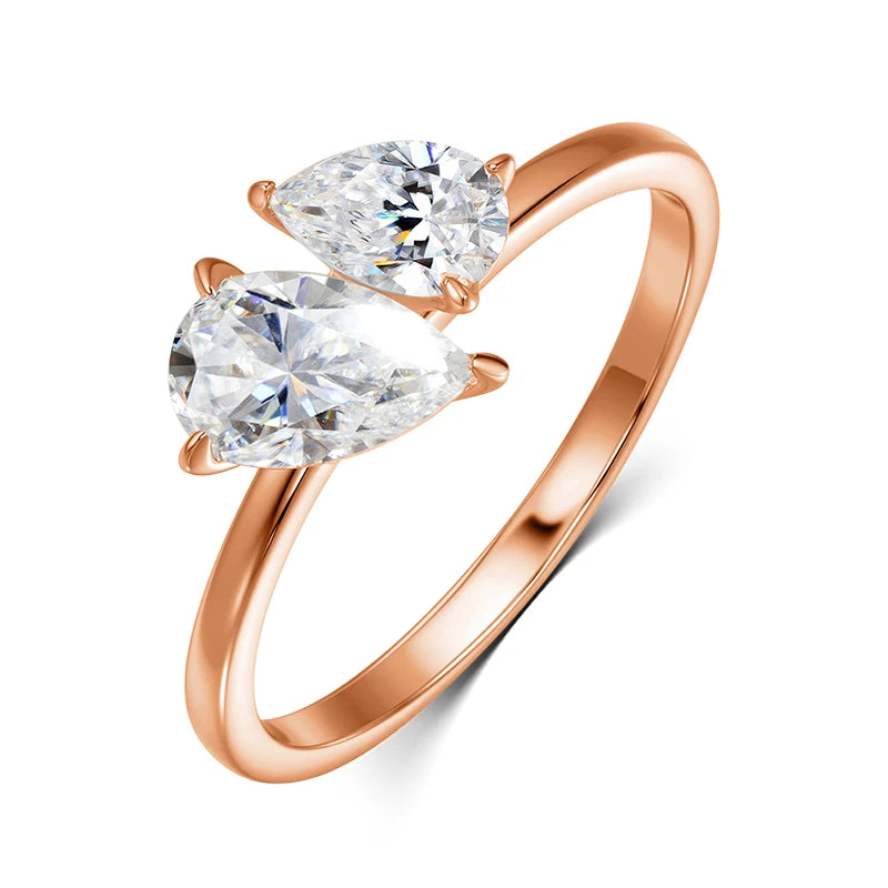 Rose gold ring featuring two pear-cut Moissanite gemstones in an asymmetric design, highlighting their brilliance and sparkle.