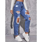 High-waisted distressed straight-leg denim jeans in light blue, featuring large rips, styled with a fitted top and white sneakers.