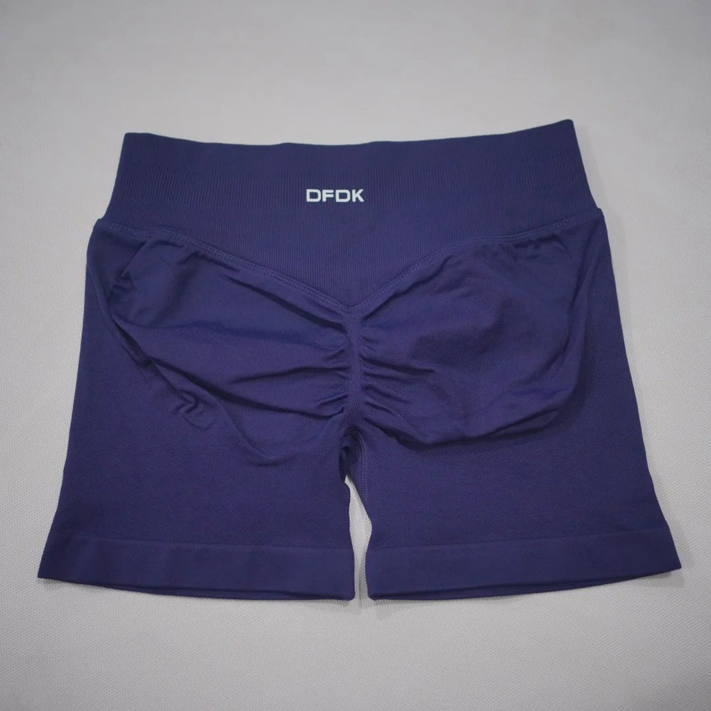 Navy blue seamless high-waisted gym shorts with a scrunch butt design and a wide elastic waistband.