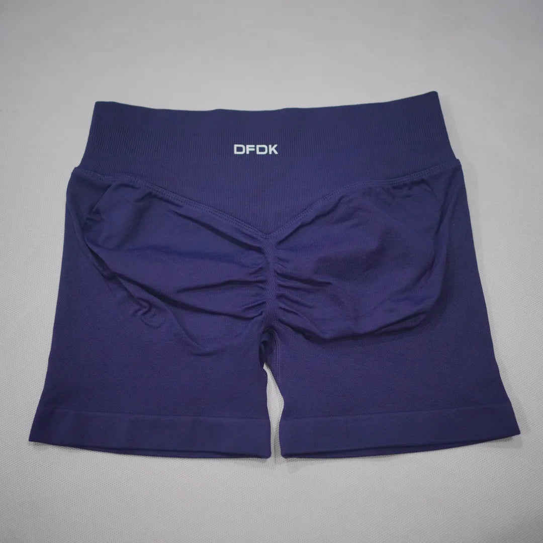 Navy blue seamless high-waisted gym shorts with a scrunch butt design and a wide elastic waistband.