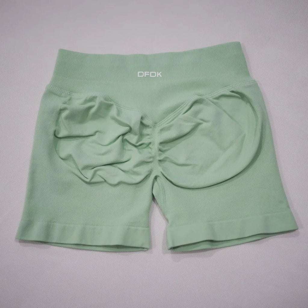 Mint green high-waisted gym shorts with a scrunch-butt design and an elastic waistband for added support.