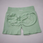 Mint green high-waisted gym shorts with a scrunch-butt design and an elastic waistband for added support.
