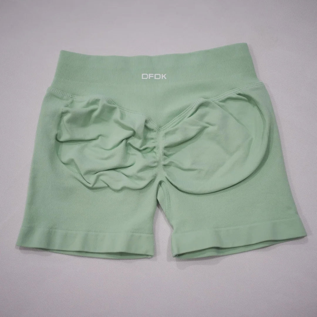 Mint green high-waisted gym shorts with a scrunch-butt design and an elastic waistband for added support.