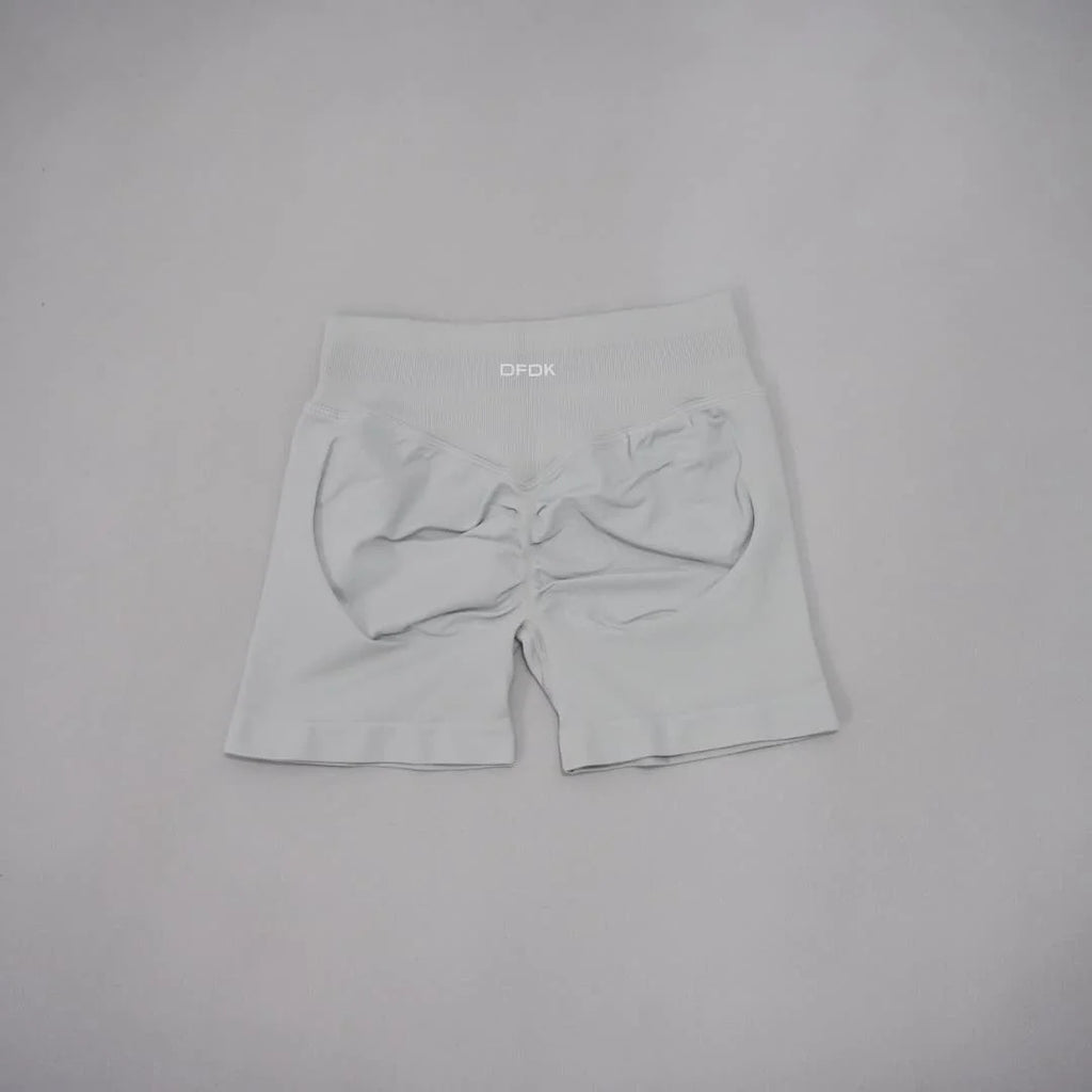 Light gray seamless high-waisted gym shorts with a scrunch-butt design and wide waistband for tummy control.