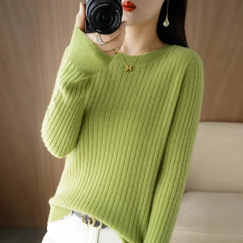 Cozy ribbed pullover in a vibrant green, featuring a crewneck and relaxed fit, paired with light denim jeans.