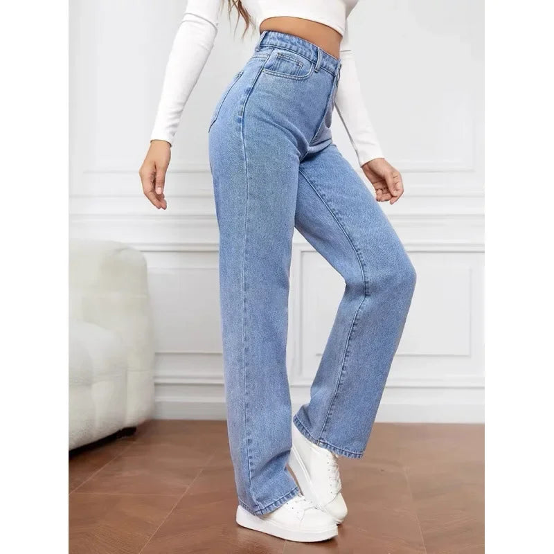 High-waisted wide-leg denim jeans in light blue, featuring a tailored fit and paired with white sneakers and a cropped top.