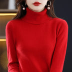 Red turtleneck sweater featuring a relaxed high collar and long sleeves, made from merino wool and cashmere blend.