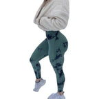 High-waisted green tie-dye leggings with scrunch detail, paired with a cozy white cropped fleece and white sneakers.
