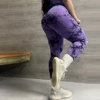 High-waisted purple leggings with a black marbled pattern, seamless design, and a model showcasing a fitted silhouette.