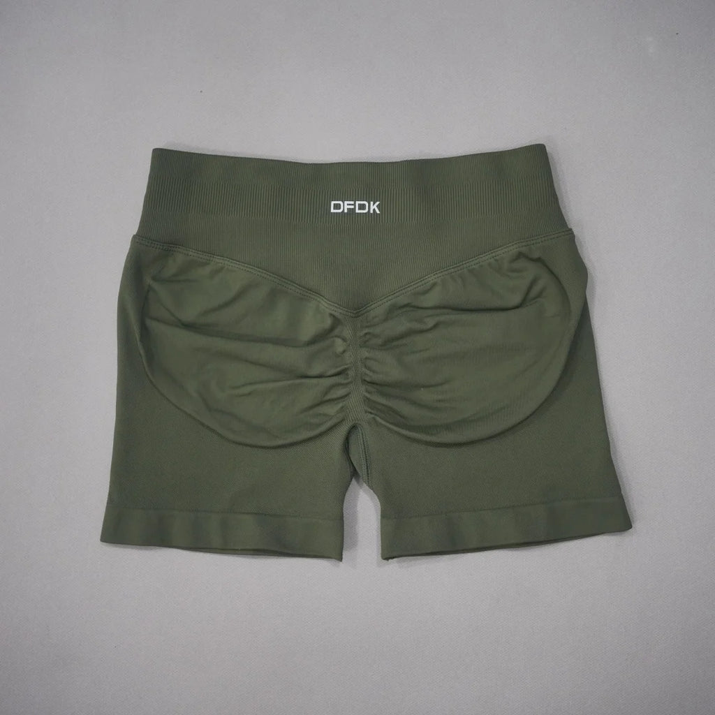 High-waisted olive green gym shorts with a seamless design and scrunch detail at the back for contouring and lift.