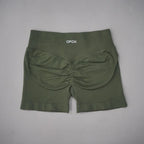 High-waisted olive green gym shorts with a seamless design and scrunch detail at the back for contouring and lift.