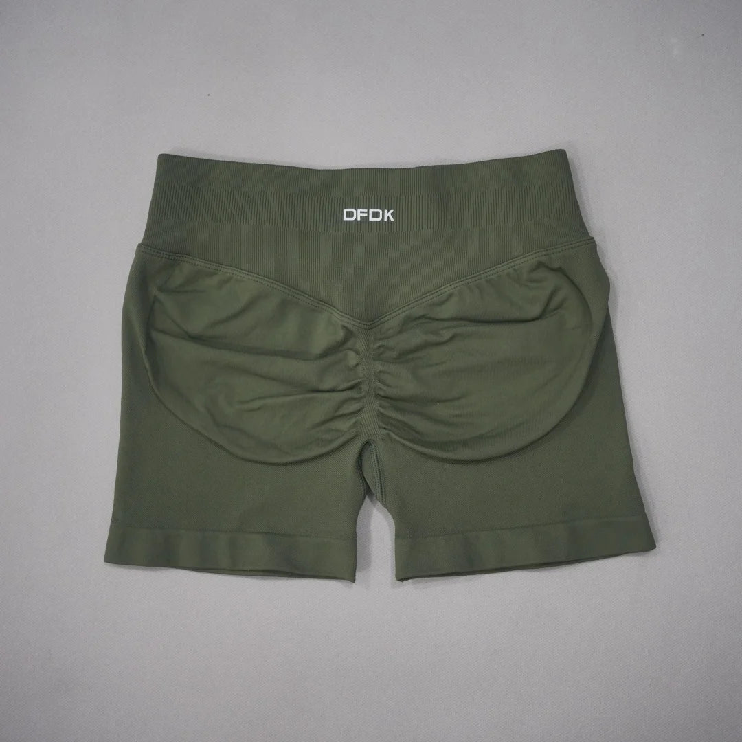 High-waisted olive green gym shorts with a seamless design and scrunch detail at the back for contouring and lift.