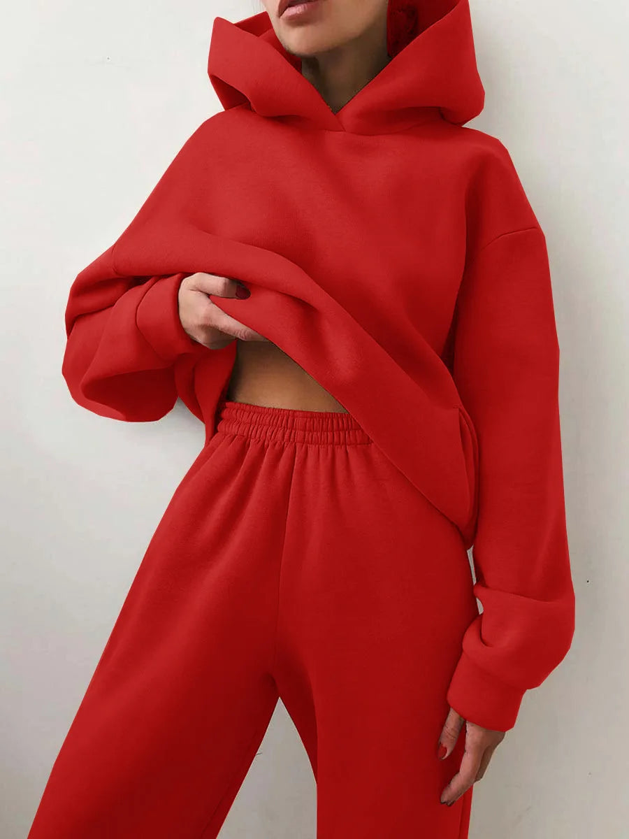 Red oversized hoodie with matching high-waisted joggers, both made from heavyweight cotton-fleece blend.