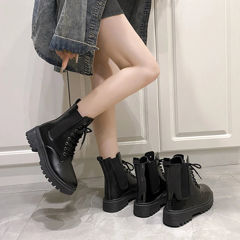Black croc-embossed Chelsea boots with a chunky platform, worn with a denim jacket and shorts, showcasing elastic side panels.