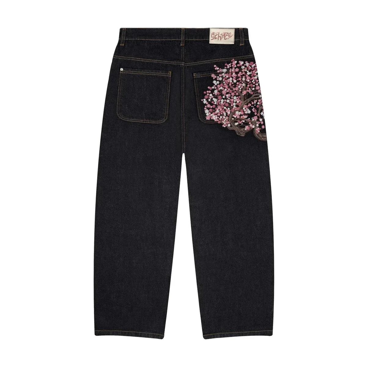 Baggy distressed denim jeans in dark wash with pink embroidered floral detail on the back pocket and relaxed wide-leg cut.
