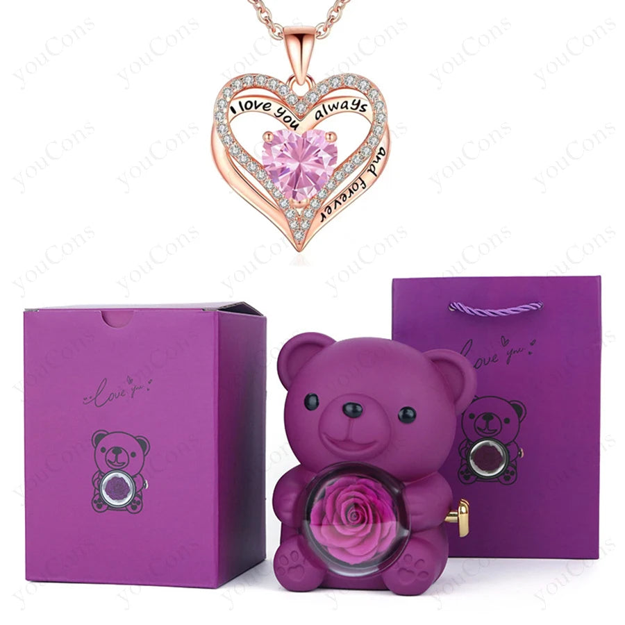 Luxury heart necklace with a pink crystal pendant and shimmering details, alongside a purple teddy bear and gift boxes.
