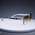 Rimless classic square sunglasses with gradient lenses and gold-tone metallic accents, featuring a black and white printed temple.