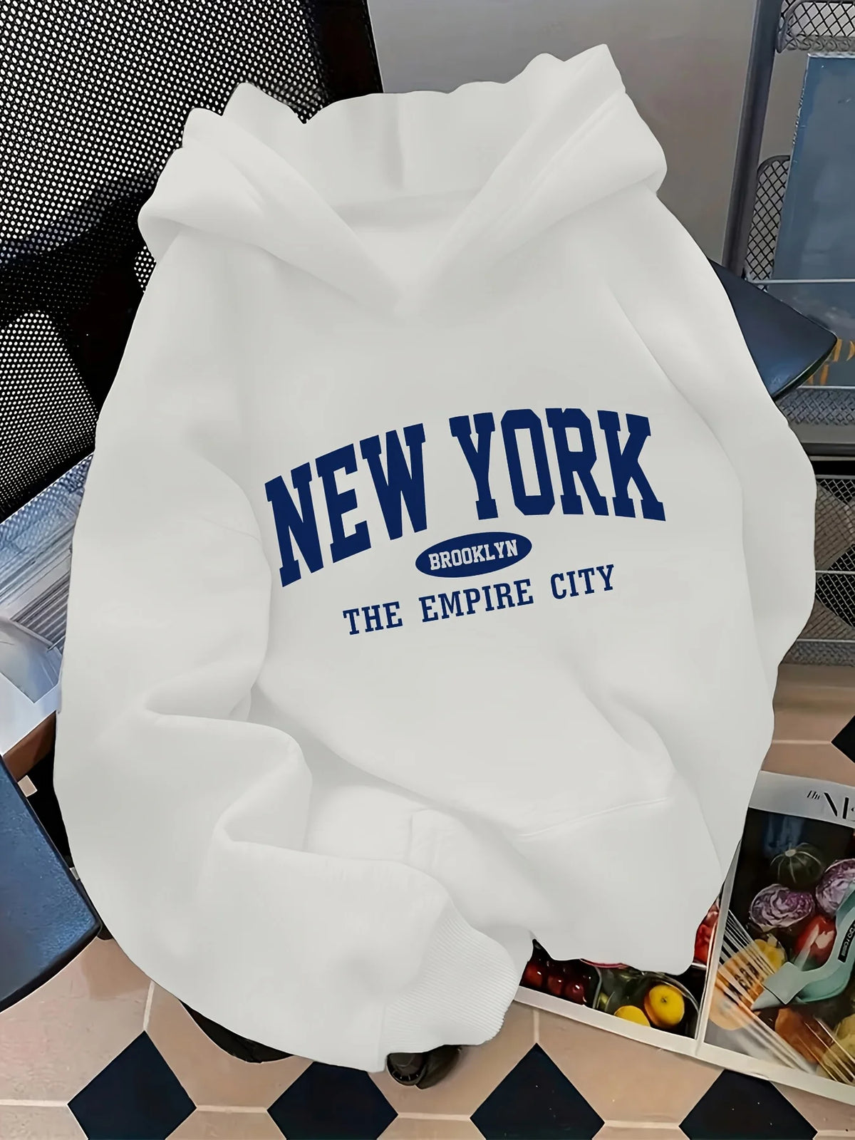 White oversized hoodie featuring a blue "NEW YORK" graphic and "BROOKLYN THE EMPIRE CITY" text.