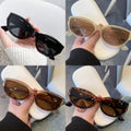 Four pairs of LOVORA™ Aura Vintage Cat-Eye Chic Sunglasses in various shades: black, translucent tan, tortoiseshell, and brown.