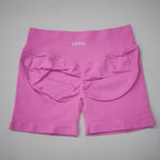 High-waisted gym shorts in bright pink, featuring a scrunch-butt design and wide elastic waistband for support.