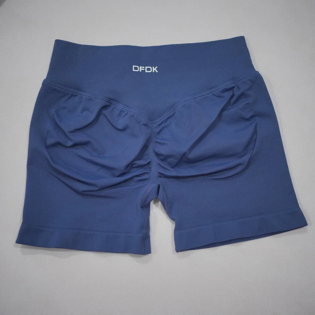 High-waisted navy gym shorts with a scrunch butt design, seamless knit fabric, and wide waistband for tummy control.