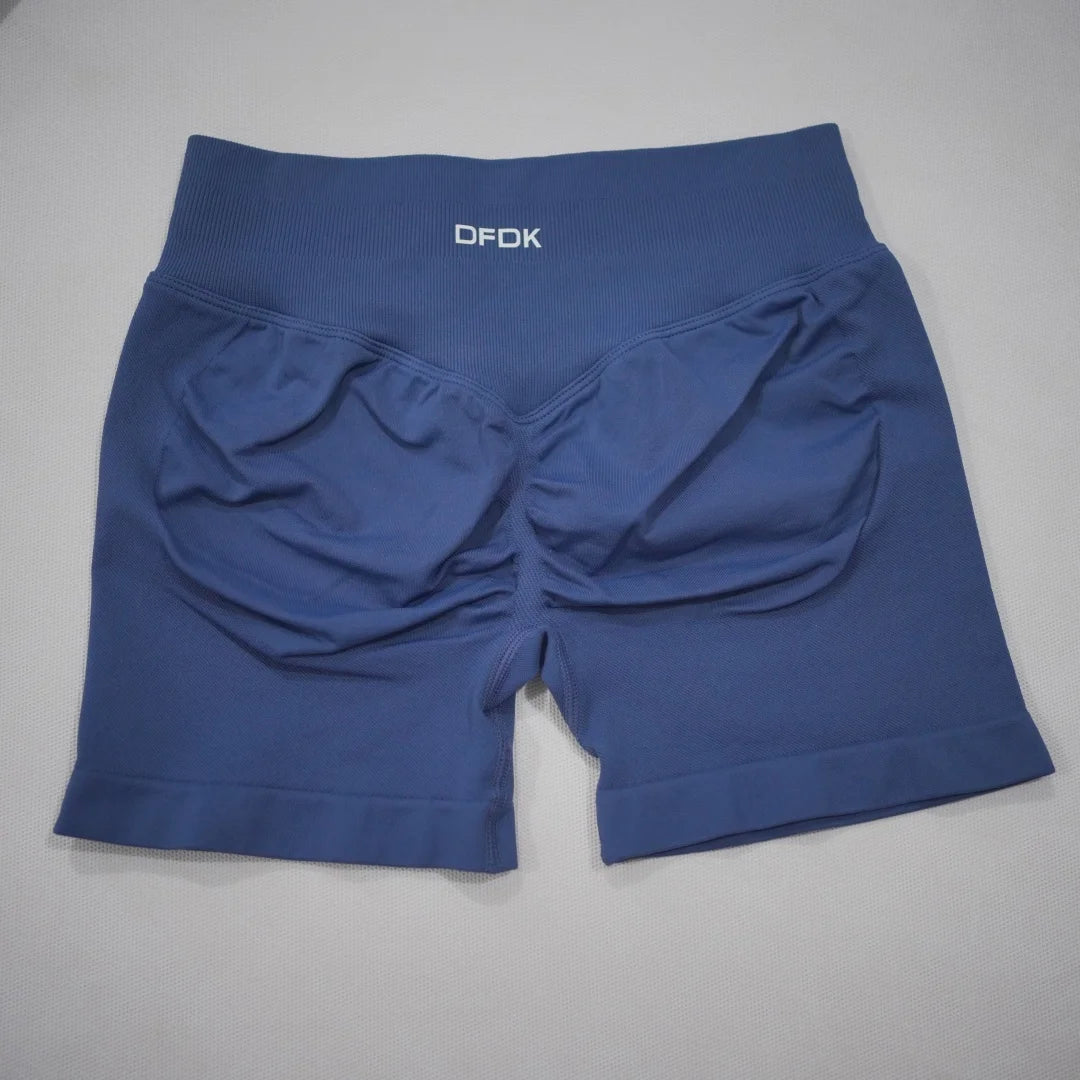 High-waisted navy gym shorts with a scrunch butt design, seamless knit fabric, and wide waistband for tummy control.