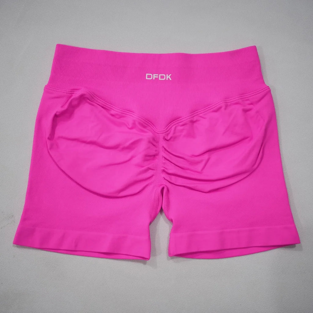 High-waisted gym shorts in vibrant pink with a seamless design and scrunch-butt detail for enhanced contouring.