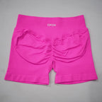 High-waisted gym shorts in vibrant pink with a seamless design and scrunch-butt detail for enhanced contouring.